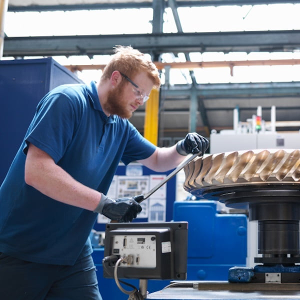 Manufacturing example, photo showing man working in a factory.