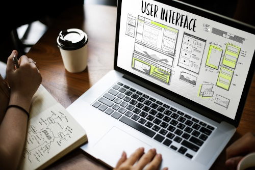 Photo of a laptop on the screen is a mockup of web-based application software.