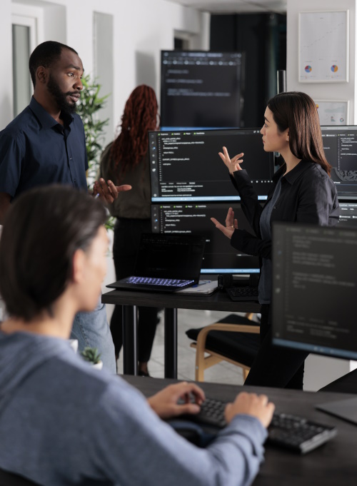 Image of a people work in a software development companies office. To represent the advantages and disadvantages of bespoke software.