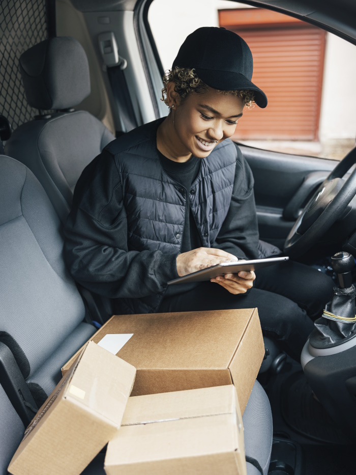 Photo of a delivery driver in a van.
