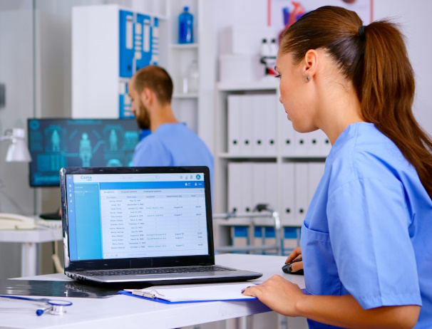Photo of medical staff using computer with healthcare software on them, to represent software training.