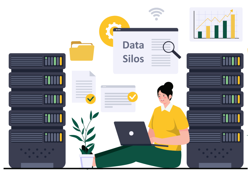 Graphic of a woman sitting with a laptop and 'siloed data' written on a screen. The woman is sat a on the floor there are 2 separate servers which are silos of data and a plant, computer folders and documents. 