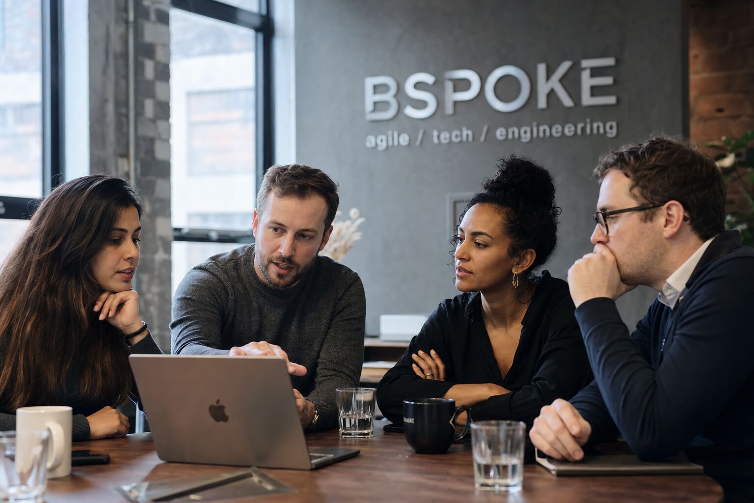BSPOKE developers collaborating around a laptop